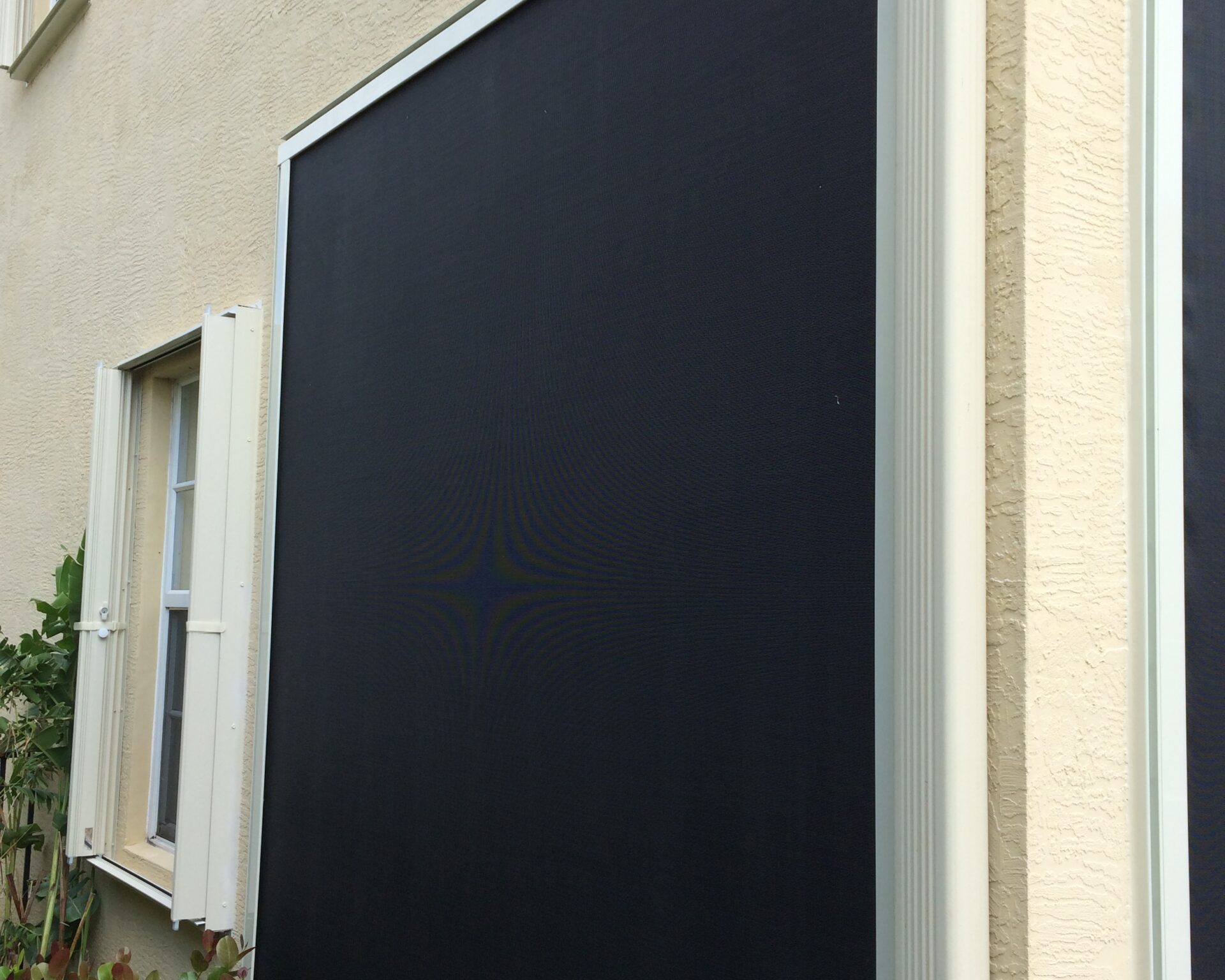 Four-sided fixed fabric hurricane screen